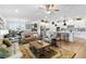 Spacious living room with an open floor plan, seamlessly connecting to the kitchen with stainless appliances and a large island at 8916 Windlass Cv, Parrish, FL 34219