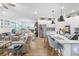 Open-concept living space with kitchen island, seating, and stainless appliances in a bright, inviting atmosphere at 8916 Windlass Cv, Parrish, FL 34219