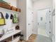 Convenient mud room featuring a bench, storage shelves, and hooks for organization near the entrance at 8916 Windlass Cv, Parrish, FL 34219