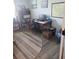 Bright home office with wood-look floors, striped rug, built-in shelving, and large wood desk at 8916 Windlass Cv, Parrish, FL 34219