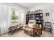 Bright office area with a leather chair, bookshelves, and a window view at 8916 Windlass Cv, Parrish, FL 34219