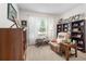 Comfortable office space with a recliner, bookshelves, and ample natural light at 8916 Windlass Cv, Parrish, FL 34219