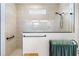 Contemporary walk-in shower featuring tiled walls, a glass partition, and a rain shower head at 8916 Windlass Cv, Parrish, FL 34219