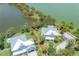 Stunning waterfront property with lush landscaping, a playground, and a private driveway at 8927 Key West Island Way, Riverview, FL 33578