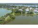 Waterfront home with lush landscaping, serene water views, and multiple docks available on the water at 8927 Key West Island Way, Riverview, FL 33578
