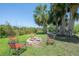 Inviting backyard with a fire pit, chairs, and hammock, perfect for relaxing and entertaining outdoors at 8927 Key West Island Way, Riverview, FL 33578