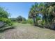 Expansive backyard with mature trees, providing ample space and privacy for outdoor activities and enjoyment at 8927 Key West Island Way, Riverview, FL 33578