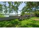 Backyard view featuring a scenic lake, lush landscaping, and an enclosed garden at 8927 Key West Island Way, Riverview, FL 33578