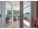 Inviting balcony with tile flooring, ceiling fan, and outdoor seating overlooking peaceful water view at 8927 Key West Island Way, Riverview, FL 33578