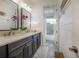 Elegant bathroom featuring double sinks, dark cabinets, and a stylish mirror, providing a luxurious feel at 8927 Key West Island Way, Riverview, FL 33578