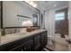 Well-lit bathroom with double sinks, modern fixtures, and a shower-tub combination, offering convenience and style at 8927 Key West Island Way, Riverview, FL 33578