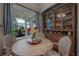 Cozy breakfast nook with wooden table, comfortable chairs, and built-in glass cabinet at 8927 Key West Island Way, Riverview, FL 33578