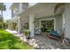 Inviting covered patio area with comfortable seating, a swing, and elegant columns at 8927 Key West Island Way, Riverview, FL 33578