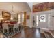 Elegant dining room featuring wood floors, plantation shutters, modern light fixture and artwork at 8927 Key West Island Way, Riverview, FL 33578