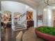 Open foyer with staircase, hardwood floors, gallery wall, and view of living area at 8927 Key West Island Way, Riverview, FL 33578