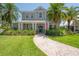Charming two-story home with beautiful landscaping and inviting front entrance with an American flag at 8927 Key West Island Way, Riverview, FL 33578
