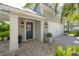 Exterior of home provides a paved driveway, lush landscaping, and a two-car garage at 8927 Key West Island Way, Riverview, FL 33578