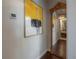 Hallway with dark hardwood floors, a full length mirror and leading to the bath and bedroom at 8927 Key West Island Way, Riverview, FL 33578