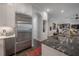 Close-up showcasing stainless steel refrigerator and a sleek, modern kitchen design with dark countertops at 8927 Key West Island Way, Riverview, FL 33578