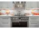 Gourmet kitchen featuring modern appliances, white cabinetry, and a sleek cooktop for culinary enthusiasts at 8927 Key West Island Way, Riverview, FL 33578