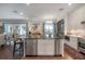 Open kitchen with a large center island, stainless steel appliances, and bright natural light at 8927 Key West Island Way, Riverview, FL 33578