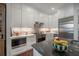 Bright kitchen featuring white cabinets, marble countertops, and stainless steel appliances at 8927 Key West Island Way, Riverview, FL 33578