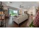 Spacious living room with hardwood floors, a ceiling fan, and sliding glass doors to the outside at 8927 Key West Island Way, Riverview, FL 33578