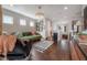 Cozy living room with hardwood floors, a green sofa, decorative art, and a stylish chandelier at 8927 Key West Island Way, Riverview, FL 33578