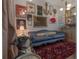 Cozy living room with eclectic artwork, plush blue sofa, and a unique dog sculpture at 8927 Key West Island Way, Riverview, FL 33578
