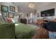 Comfortable living room with hardwood floors, a green sofa, decorative art, and a stylish chandelier at 8927 Key West Island Way, Riverview, FL 33578