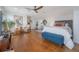 Spacious main bedroom with hardwood floors, sitting area, en suite, and decor at 8927 Key West Island Way, Riverview, FL 33578