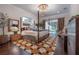 Spacious main bedroom with four-poster bed, chandelier, and access to the outdoor patio at 8927 Key West Island Way, Riverview, FL 33578