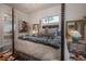 A plush four poster bed takes center stage in this bedroom with ensuite bath at 8927 Key West Island Way, Riverview, FL 33578
