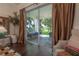 Views from main bedroom to backyard patio with hanging bed and view of manicured grounds at 8927 Key West Island Way, Riverview, FL 33578