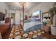 Main bedroom with four poster bed, custom rug, and lots of natural light at 8927 Key West Island Way, Riverview, FL 33578