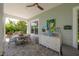 Covered outdoor dining space with ample seating, complemented by stylish decor at 8927 Key West Island Way, Riverview, FL 33578