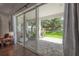 A view from inside the home to the covered outdoor patio and the backyard at 8927 Key West Island Way, Riverview, FL 33578