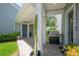 A covered side porch featuring a grill, cactus, and a brick floor at 8927 Key West Island Way, Riverview, FL 33578