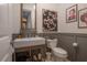 Stylish powder room featuring modern fixtures, a vessel sink, and eye catching decorations at 8927 Key West Island Way, Riverview, FL 33578