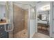 Glass enclosed shower with built in seat and designer tile work and view to the main bedroom at 8927 Key West Island Way, Riverview, FL 33578