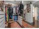 Spacious walk-in closet featuring custom shelving and a mirrored wall, offering ample storage for clothing and accessories at 8927 Key West Island Way, Riverview, FL 33578