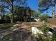 Spacious backyard with mature trees and partial fencing, offering privacy and outdoor potential at 9025 1St Ne St, St Petersburg, FL 33702
