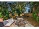 Relaxing backyard with a hammock, fire pit, outdoor seating, mature trees, and a wood fence at 9025 1St Ne Ave, St Petersburg, FL 33702