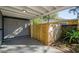 Enclosed carport area featuring a wooden fence and a glimpse of the neighboring house at 9025 1St Ne Ave, St Petersburg, FL 33702