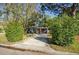 Charming single-story home with a well-manicured front yard, complemented by lush trees and greenery at 9025 1St Ne St, St Petersburg, FL 33702
