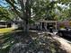 Charming home with a covered carport, nestled under a large shade tree at 9025 1St Ne Ave, St Petersburg, FL 33702