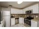 Bright kitchen showcases stainless appliances, white cabinets, and plenty of counter space at 9025 1St Ne St, St Petersburg, FL 33702