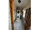Narrow laundry room featuring a stacked washer/dryer and hot water tank, amid ongoing home renovations at 9025 1St Ne St, St Petersburg, FL 33702