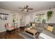 Inviting living room with hardwood floors, a comfortable couch, and ample natural light at 9025 1St Ne St, St Petersburg, FL 33702
