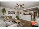 Cozy living room with hardwood floors, a sectional sofa, and an open view to the kitchen at 9025 1St Ne St, St Petersburg, FL 33702